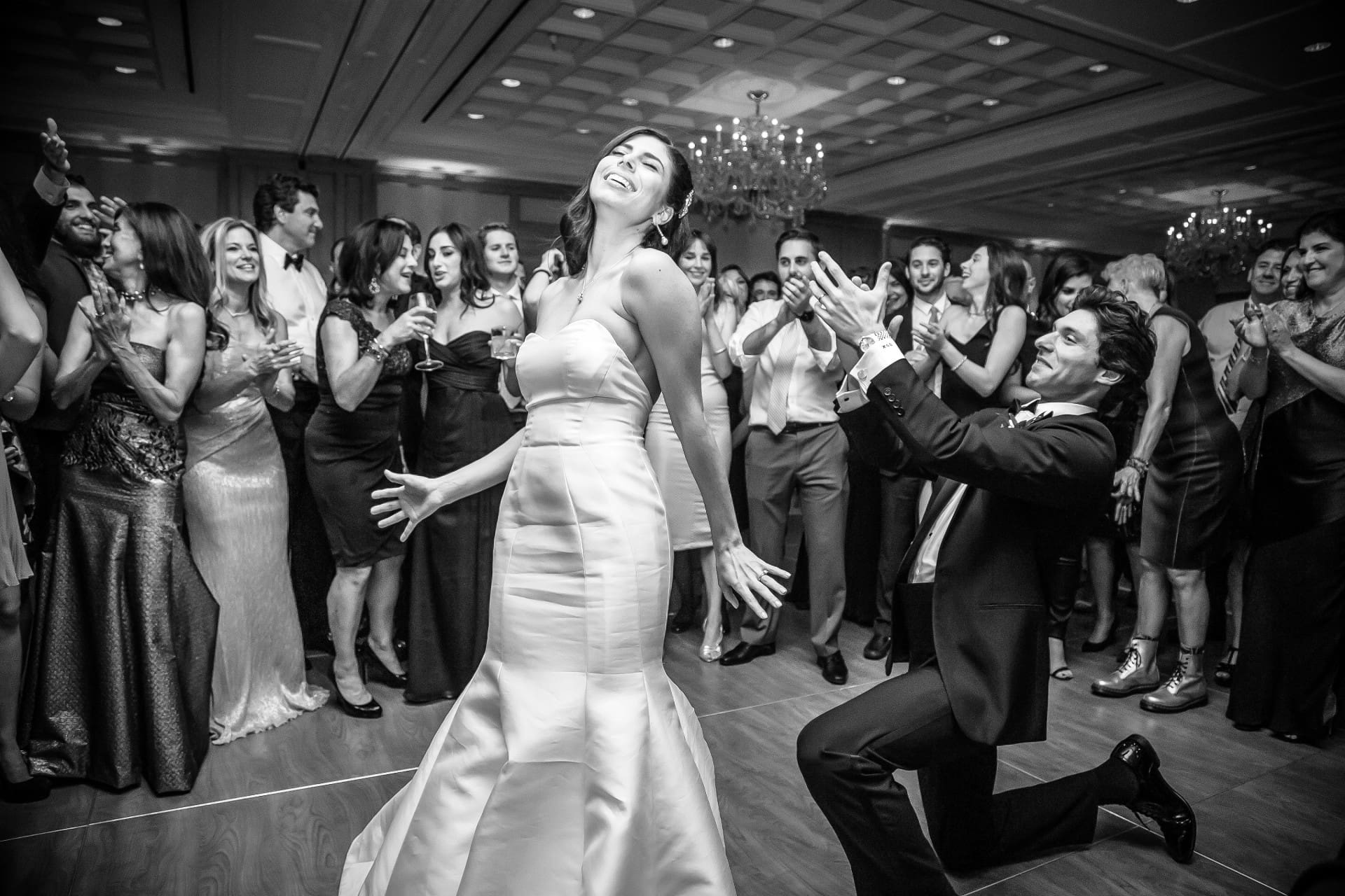 Bride dancing with wedding guests during a lively reception celebration